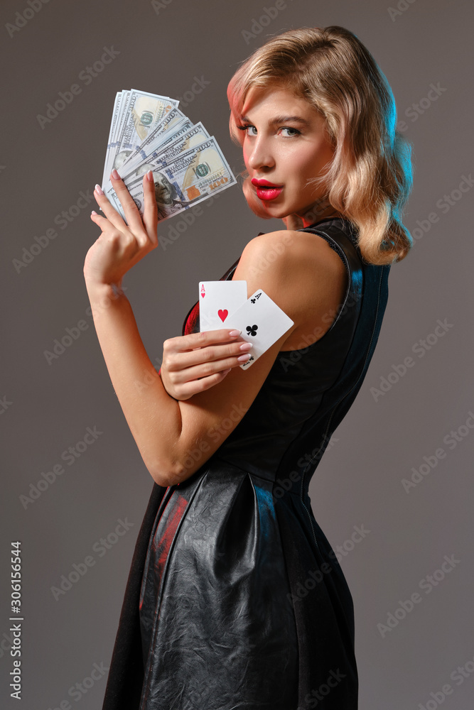 Premium Photo | Charming blonde woman with bright makeup in black stylish  dress is showing two playing cards and posing against gray studio  background concept of gambling entertainment poker casino closeup