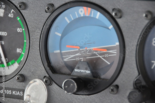Single engine piston aircraft attitude indicator close up shot during turn, orange indication with blue sky and rate and angle of turn