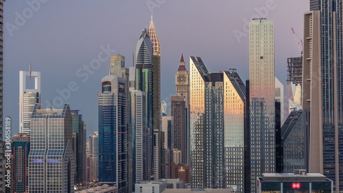 Aerial view of new skyscrapers and tall buildings in Dubai day to night timelapse