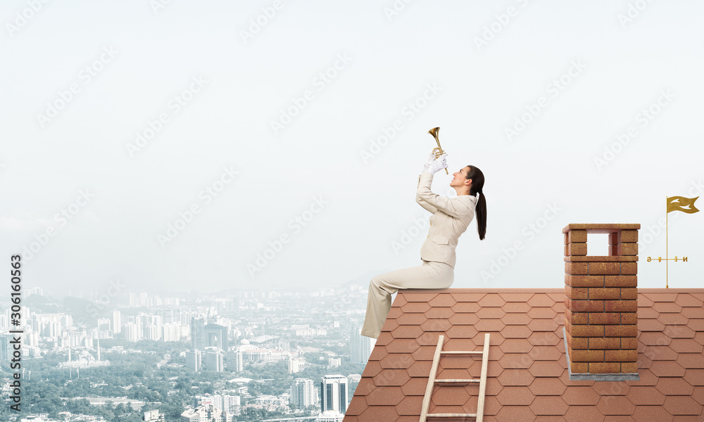 Beautiful young woman playing trumpet on roof Beautiful young woman playing trumpet on roof