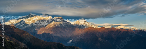 Panoramic view of the majestic Himalayan peaks - Annapurna IV and Annapurna II, covered with clouds illuminated by the sunset.