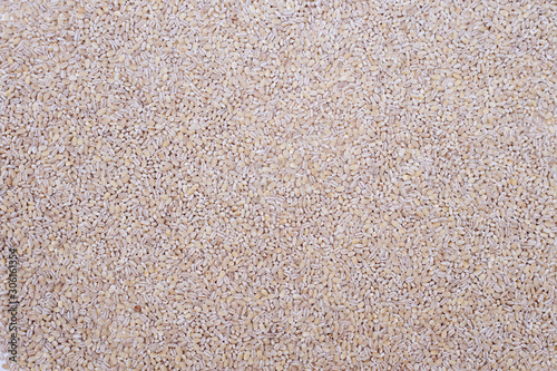 Pearl barley groats background. Top view, copy space photo