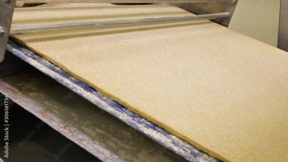 Dough piece at the conveyor of a bakery factory Dough piece at the conveyor of a bakery factory