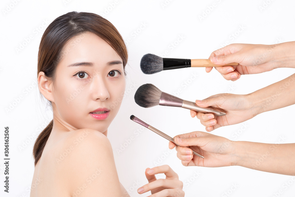 Portrait of beautiful woman with make-up brushes on white background Portrait of beautiful woman with make-up brushes on white background
