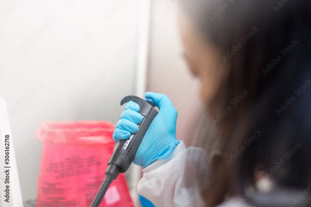 Scientist or lab worker hand in glove using pipette dropper dropping ...