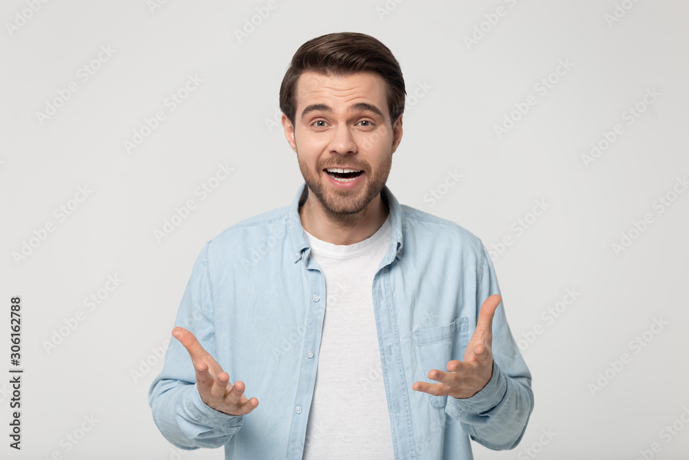 Surprised millennial man feel amazed isolated in studio Surprised millennial man feel amazed isolated in studio