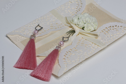 Handmade tassel earrings. Greeting card. On white background.