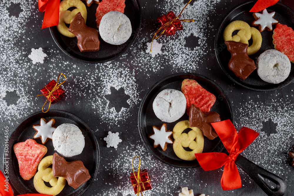 Top view of mini iron skillets. Christmas cookie, chocolate and candy. Top view of mini iron skillets. Christmas cookie, chocolate and candy.