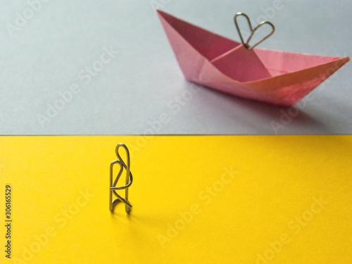 paper clip installation. lovers ashore and paper boat