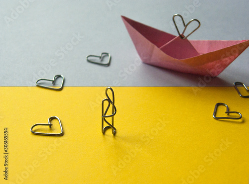 paper clip installation. lovers ashore and paper boat