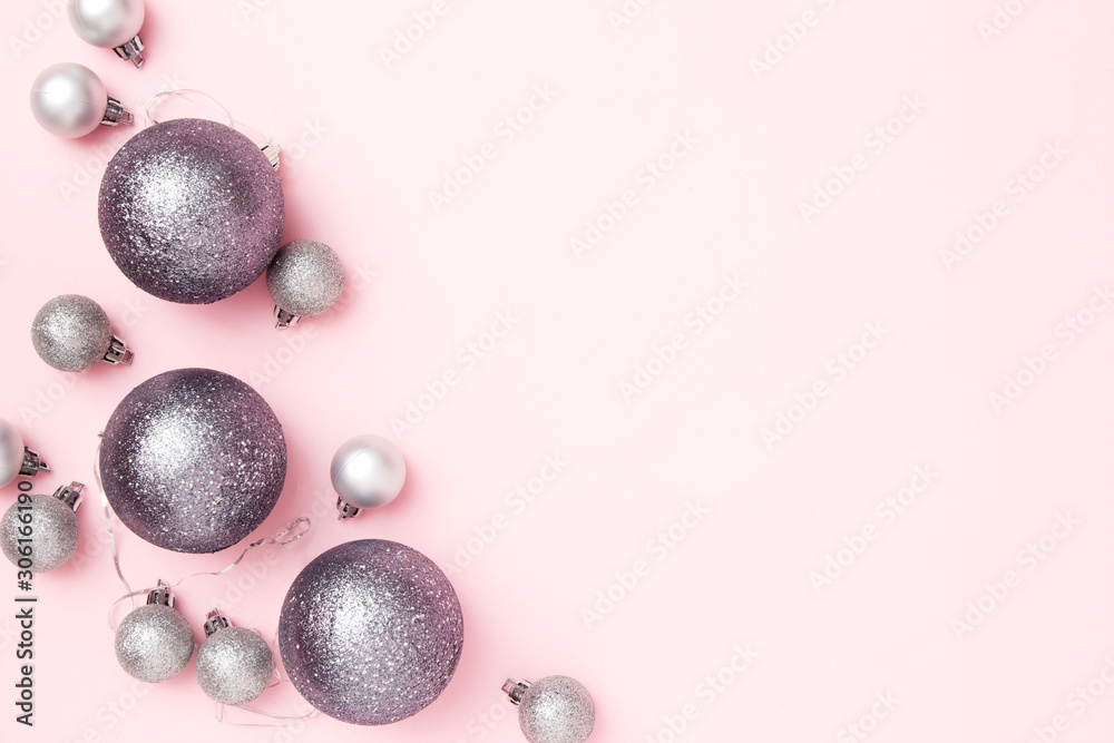 Fototapeta premium Christmas greeting card composition. Christmas silver balls on pink pastel background. Flat lay, top view, copy space