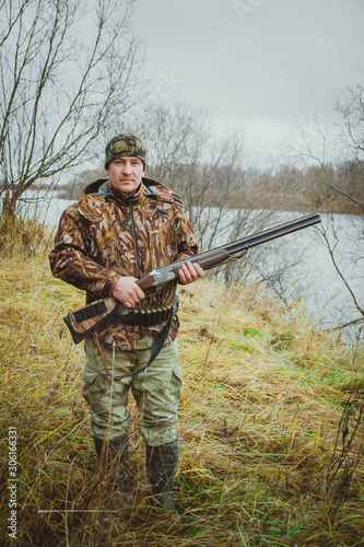 Autumn hunting wild ducks and hunter with a gun.