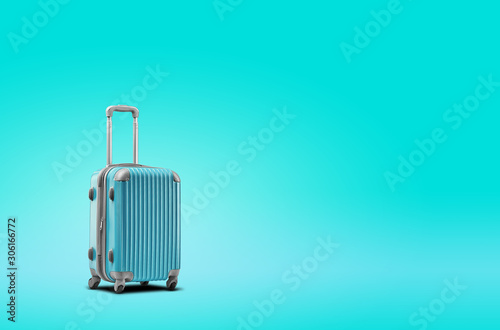 Blue suitcase is standing against turquoise background. A realistic shadow is drawn in under it. Collage. Copy space, close-up.