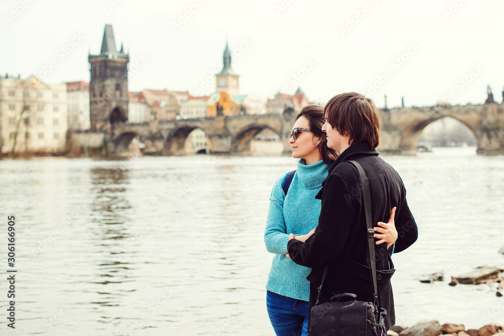 Honeymoon travels in Europe. Young couple enjoying great view on Prague city. Love, honeymoon, lifestyle. Travelling in Europe