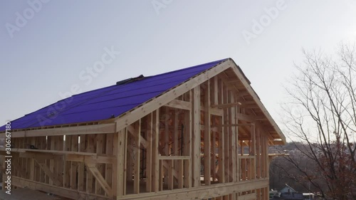 Wallpaper Mural Aerial view of attic exterior of wooden house under construction. Roof is covered with insulation material, the roof base Torontodigital.ca