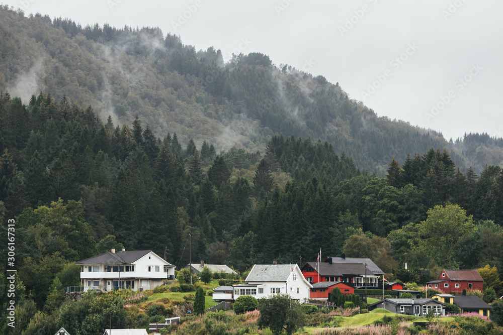 Small village near foggy mountains in Norway