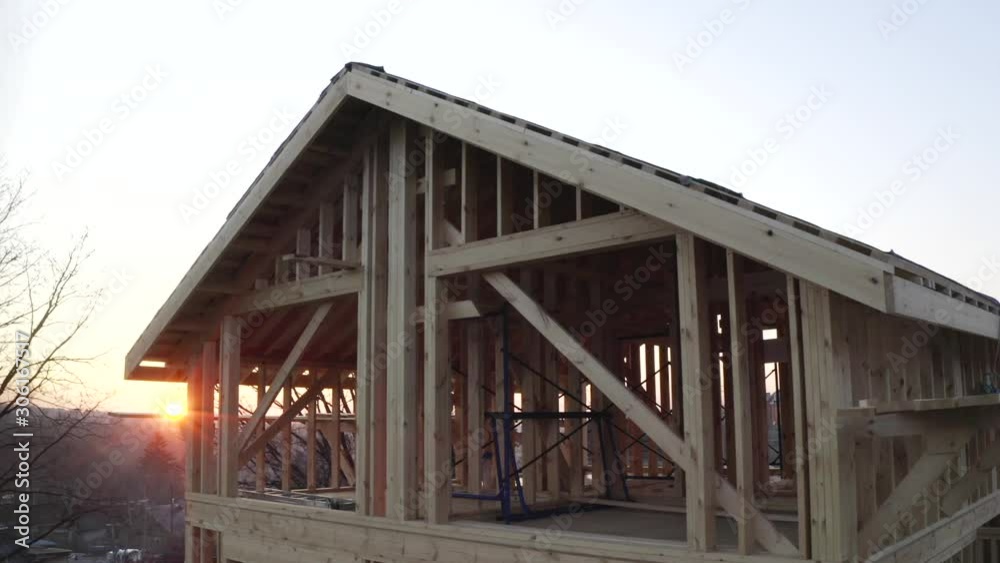 Aerial view of attic of wooden house under construction. Evening, sundown Aerial view of attic of wooden house under construction. Evening, sundown