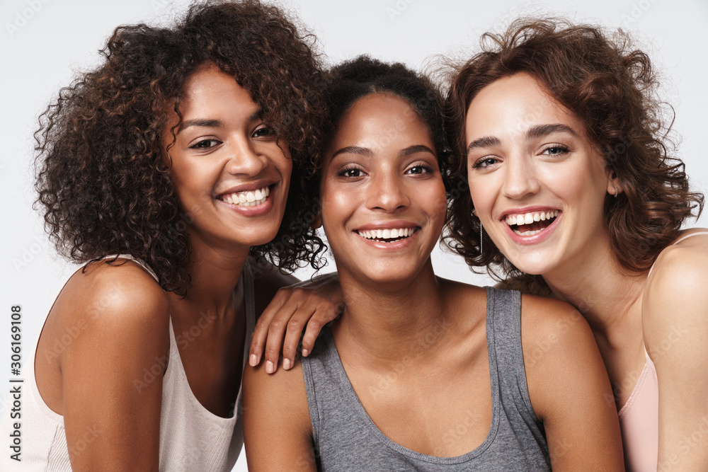 Portrait of young multiracial women standing together and smiling - obrazy, fototapety, plakaty 