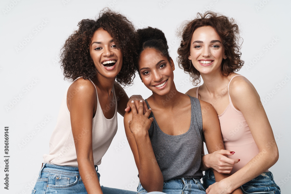 Portrait of gorgeous multiracial women standing together and smiling - obrazy, fototapety, plakaty 