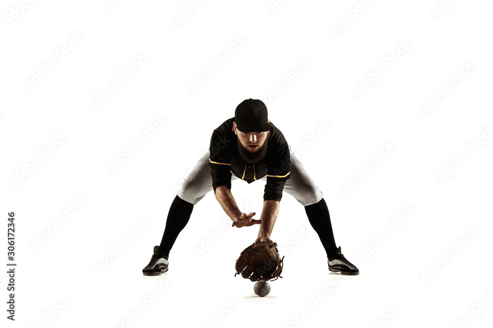 Baseball player, pitcher in a black uniform practicing and training isolated on a white background. Young professional sportsman in action and motion. Healthy lifestyle, sport, movement concept.