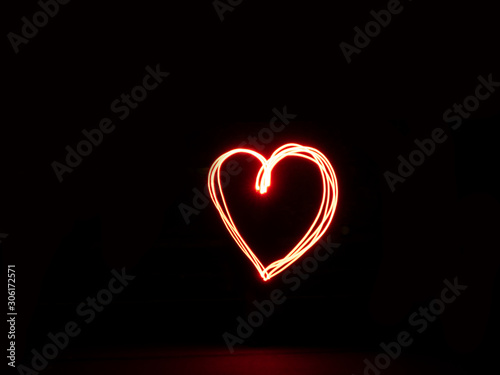 Long exposure heart red colour outline outside sign light painting with a red flashlight