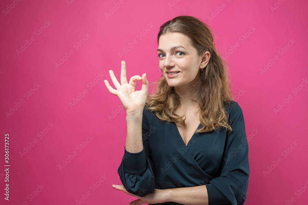 Happy young caucasian female pointing fingers away, showing copy space for your text Happy young caucasian female pointing fingers away, showing copy space for your text