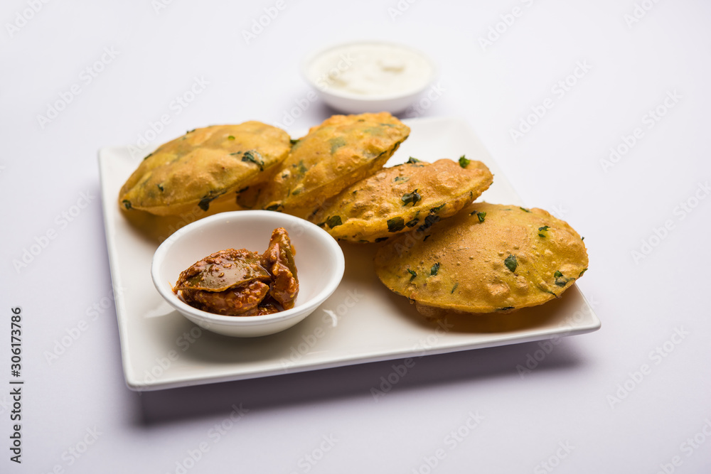 Methi Poori or Puri made using Fresh fenugreek leaves missed with wheat flour, by making small pancake size shapes deep fried in oil, served with tea Methi Poori or Puri made using Fresh fenugreek leaves missed with wheat flour, by making small pancake size shapes deep fried in oil, served with tea