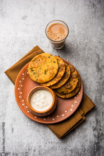 Methi Poori or Puri made using Fresh fenugreek leaves missed with wheat flour, by making small pancake size shapes deep fried in oil, served with tea