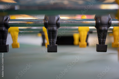 Fototapeta Naklejka Na Ścianę i Meble -  Close-up of a football table with yellow and black figures