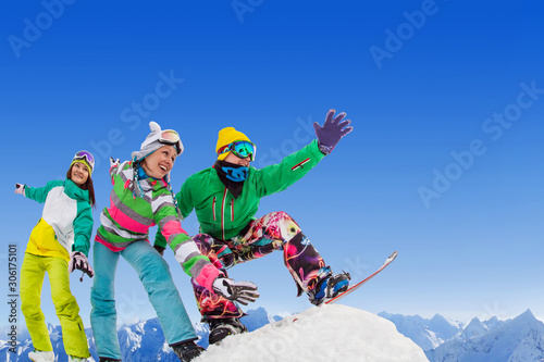 frieds  snowboarders on ski resort