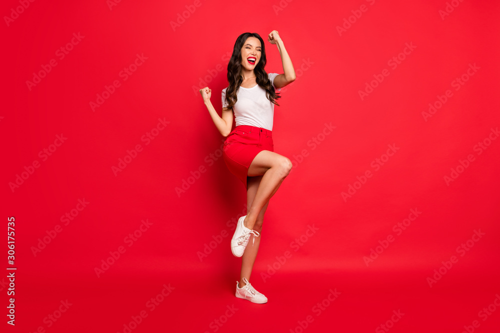 Full length body size view of nice glamorous gorgeous attractive lovely cheerful cheery ecstatic wavy-haired girl celebrating accomplish isolated over bright vivid shine vibrant red color background
