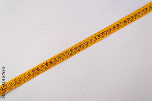 Tailor measuring tapes. Yellow and white sides with numbers showed in centimeters