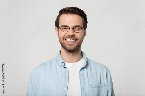 Happy Caucasian man in glasses isolated on studio background