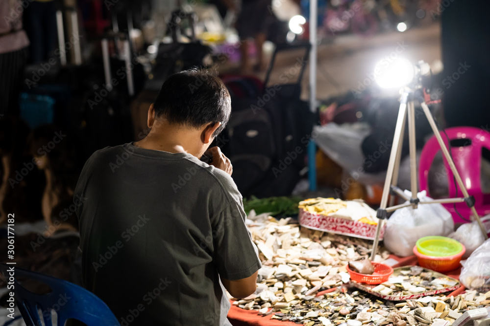 man watching amulets on amulet market