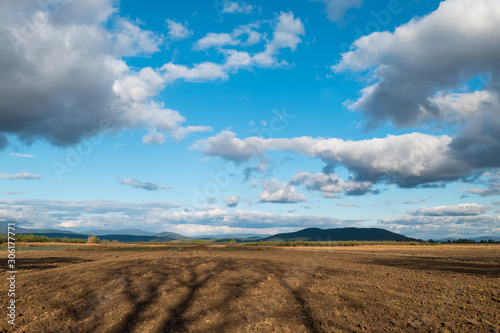 Ploughed field under cloudy sky