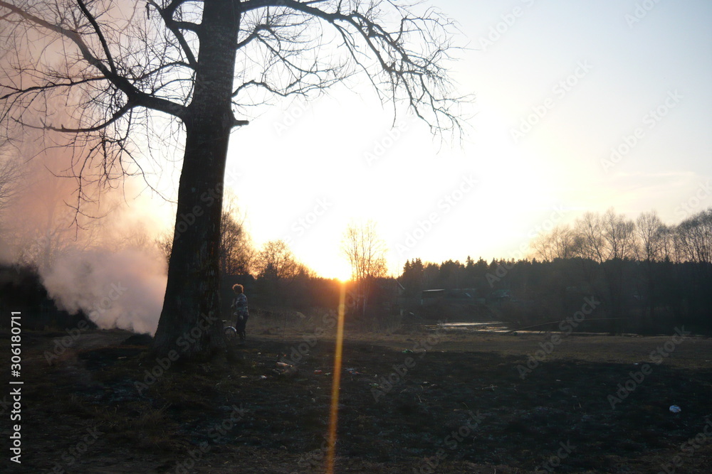 the man burns the grass at sunset the man burns the grass at sunset