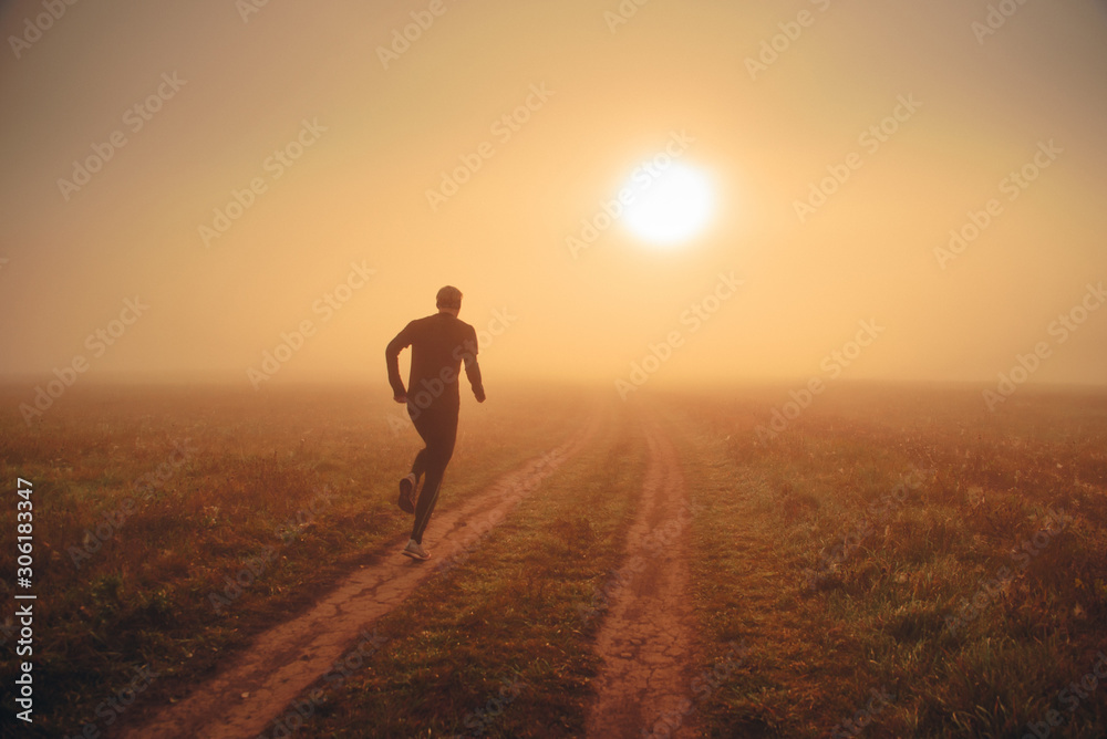 Health and fitness concept photo. Alone runner train in orange autumn morning nature