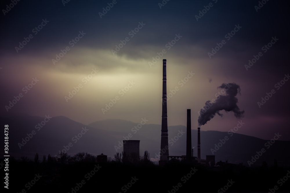 Smog hell - sunrise.  View from afar the city and a factory chimney with lots of smoke and smog.  Europe, landscape Slovakia, Novaky. Chemical factory. Abstract. Global warming of the earth.