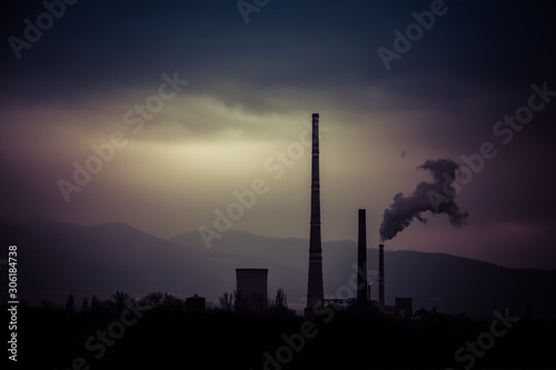 Smog hell - sunrise. View from afar the city and a factory chimney with lots of smoke and smog. Europe, landscape Slovakia, Novaky. Chemical factory. Abstract. Global warming of the earth.