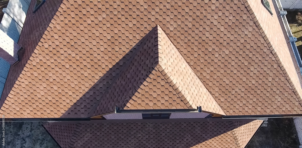 Bituminous tile for a roof. House with a roof from a bituminous tile. a roof from a bituminous tile. Moder Bituminous tile for a roof. House with a roof from a bituminous tile. a roof from a bituminous tile. Moder