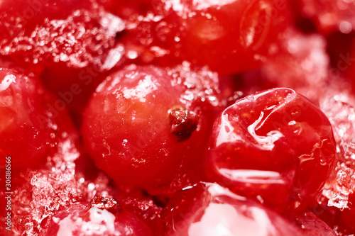 Abstract red winter background. Frozen red currants close-up. Blurred. Macro photo.