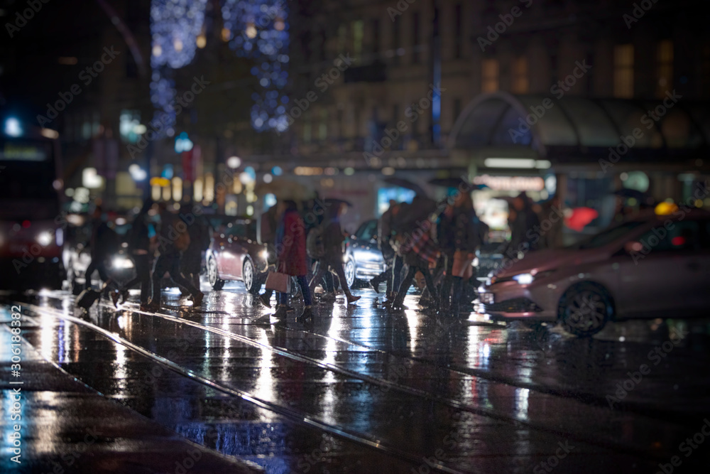 crowd of people walking on night streets in the city 