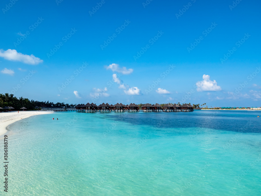Maldives island with beach water bungalows and palm trees, South Male Atoll, Maldives