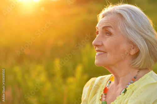 Portrait of happy senior woman smiling in park
