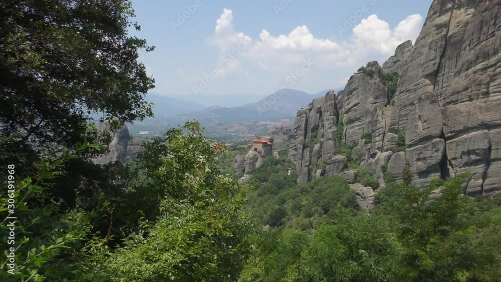 Monastary of St. Nicholas Anapausas in Meteora. Thessaly mountains, Greece. Hot summer day. Zoom out. Monastary of St. Nicholas Anapausas in Meteora. Thessaly mountains, Greece. Hot summer day. Zoom out.