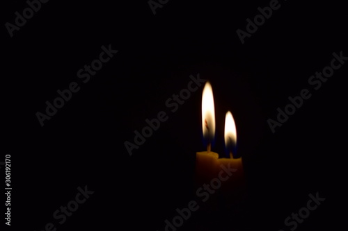 Two candle lights are shining.