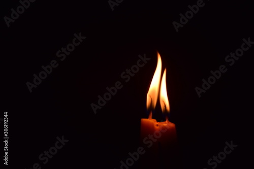 The flame of the candle in the dark