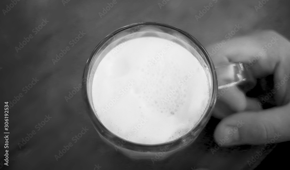 beer mug on a table in a male hand in a pub