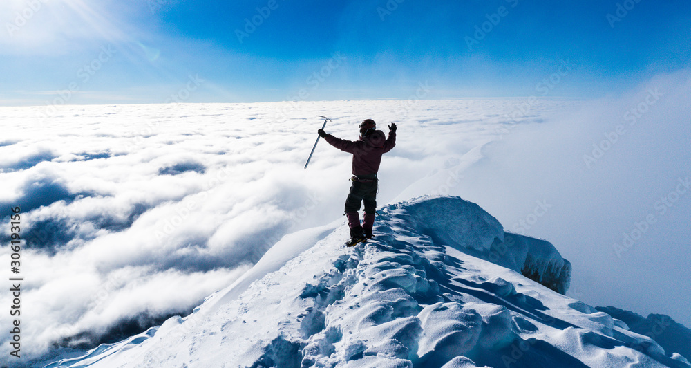 Alpinist in the summit of a mountain