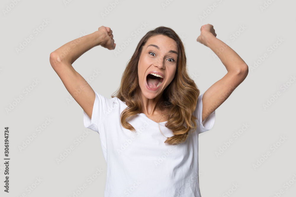 Happy excited woman celebrating win, raising hands, shouting Happy excited woman celebrating win, raising hands, shouting